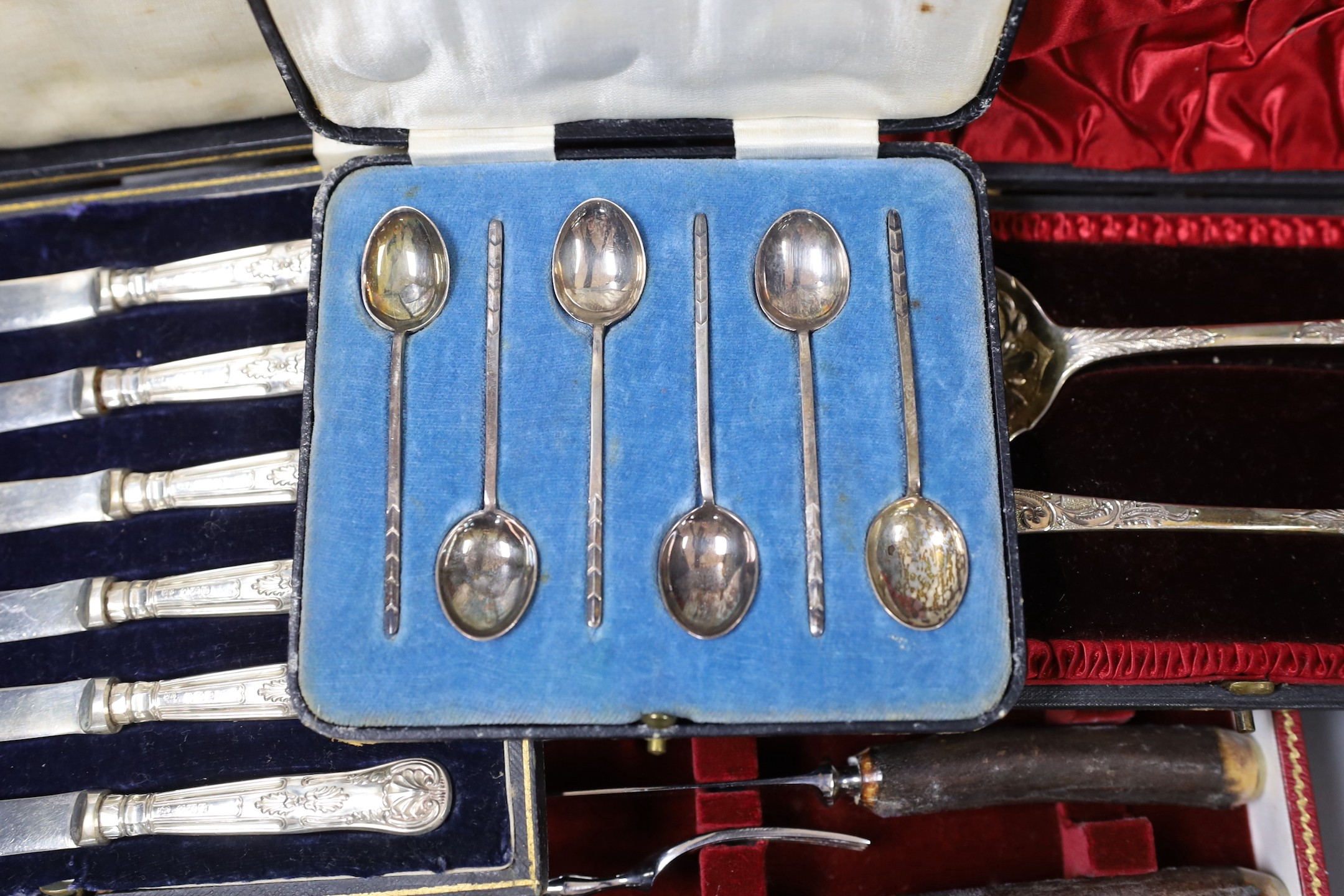 Four cased sets of flatware, including silver 'berry spoons', tea knives, teaspoons and horn handles knives and forks.